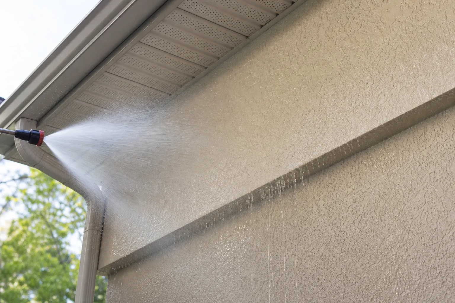 Soft washing Jacksonville stucco siding with a low-pressure fan rinse