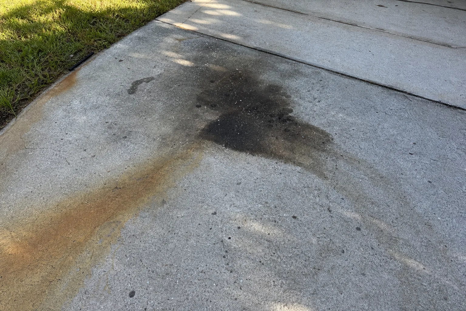 Before specialty oil and rust stain cleaning on Jacksonville concrete